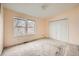 Upstairs bedroom with carpet and double door closet at 16373 E 17Th Pl # B, Aurora, CO 80011