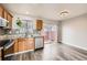 Kitchen features granite counters, wood cabinets and sliding door to patio at 16373 E 17Th Pl # B, Aurora, CO 80011