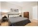 Bright bedroom features hardwood floors, neutral paint, and a wooden dresser with modern bedside tables at 2645 W 24Th Ave, Denver, CO 80211