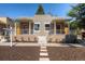 Charming home featuring a stone facade, red doors, and well-maintained front yard at 2645 W 24Th Ave, Denver, CO 80211