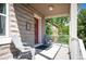 Inviting covered porch with seating provides a relaxing outdoor space with durable stone exterior at 2645 W 24Th Ave, Denver, CO 80211