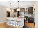 Modern kitchen features granite countertops, stainless steel appliances, pendant lighting, and dark wood cabinets at 2645 W 24Th Ave, Denver, CO 80211