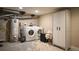 Practical laundry area with washer, dryer, water heater, and storage cabinet at 2645 W 24Th Ave, Denver, CO 80211