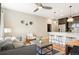 Open-concept living space with barstool seating, grey sofa, and hardwood floors at 2645 W 24Th Ave, Denver, CO 80211