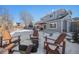 Snowy backyard with fire pit and seating area at 5907 E Tabor Pl, Castle Rock, CO 80104