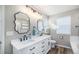 Modern bathroom with double sinks, a large mirror, and updated fixtures at 5907 E Tabor Pl, Castle Rock, CO 80104