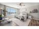 Spacious primary bedroom features a large window, a ceiling fan, and hardwood floors at 5907 E Tabor Pl, Castle Rock, CO 80104