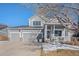 Two-story house with gray siding, attached garage, and front porch at 5907 E Tabor Pl, Castle Rock, CO 80104