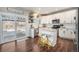 Modern kitchen with white cabinets, granite countertops, and island at 5907 E Tabor Pl, Castle Rock, CO 80104