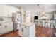 Modern kitchen with white cabinets, granite countertops, and island at 5907 E Tabor Pl, Castle Rock, CO 80104