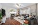 Spacious living room with hardwood floors, fireplace, and ample natural light at 5907 E Tabor Pl, Castle Rock, CO 80104