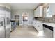 Modern kitchen with stainless steel appliances and a view into the adjacent dining area at 12300 Cameron Dr, Brighton, CO 80603