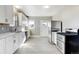 Modern kitchen with white cabinets, stainless steel appliances, and vinyl flooring at 12300 Cameron Dr, Brighton, CO 80603