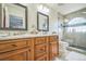 A spacious bathroom features dual sinks, wood cabinetry, and a shower at 20338 E 48Th Dr, Denver, CO 80249