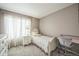 A clean bedroom features a bright window, desk, and carpeted floor at 20338 E 48Th Dr, Denver, CO 80249
