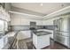 Modern kitchen with stainless steel appliances, an island, and granite countertops at 20338 E 48Th Dr, Denver, CO 80249