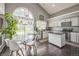 Bright kitchen with modern appliances, granite countertops, and a dining area at 20338 E 48Th Dr, Denver, CO 80249