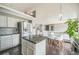 Stylish kitchen with an island, granite countertops, stainless appliances, and a bright dining area at 20338 E 48Th Dr, Denver, CO 80249