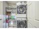 A convenient laundry room features a stacked washer and dryer to save space at 20338 E 48Th Dr, Denver, CO 80249