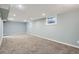 Finished basement with carpeting, recessed lighting, and natural light from two windows at 921 Dakin St, Denver, CO 80221