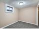 Finished basement featuring neutral paint, gray carpeting, and a window for natural light at 921 Dakin St, Denver, CO 80221