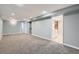 Spacious finished basement with gray walls, neutral carpet, recessed lighting, and multiple doorways at 921 Dakin St, Denver, CO 80221