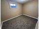 Cozy bedroom with carpeted floor and a window for natural light at 921 Dakin St, Denver, CO 80221