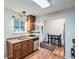 The modern kitchen features stainless steel appliances, wood floors, and granite counters at 921 Dakin St, Denver, CO 80221