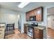 Updated kitchen boasts stainless steel appliances, granite countertops, and wood flooring at 921 Dakin St, Denver, CO 80221