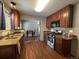 Traditional kitchen featuring wood cabinets, granite counters, and stainless steel appliances at 921 Dakin St, Denver, CO 80221