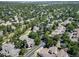 Expansive aerial view showcasing a neighborhood with mature trees and a mix of single-Gathering homes and townhouses at 7630 S Monaco Way, Centennial, CO 80112