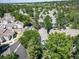 Aerial view of a well-maintained neighborhood with mature trees, manicured lawns, and a mix of housing styles at 7630 S Monaco Way, Centennial, CO 80112