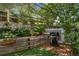 Charming backyard featuring a built-in garden, mature trees, and a grilling area perfect for outdoor entertaining at 7630 S Monaco Way, Centennial, CO 80112