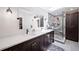 Beautiful primary bathroom with double sinks, wood cabinets, and a walk-in shower at 7630 S Monaco Way, Centennial, CO 80112