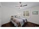Cozy bedroom with ceiling fan, shuttered window, and a comfortable queen-sized bed at 7630 S Monaco Way, Centennial, CO 80112