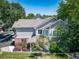 Well-maintained home exterior surrounded by mature trees and lush landscaping at 7630 S Monaco Way, Centennial, CO 80112