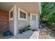 Inviting front entrance adorned with potted flowers and a well-maintained walkway at 7630 S Monaco Way, Centennial, CO 80112