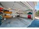 Spacious and organized garage with ample storage cabinets, a work area, and an open door at 7630 S Monaco Way, Centennial, CO 80112
