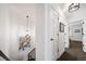 Hallway featuring modern lighting fixtures and artwork, leading to various rooms in the home at 7630 S Monaco Way, Centennial, CO 80112