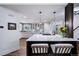 Beautiful kitchen with white cabinets, stainless steel appliances, large island with seating and flowers at 7630 S Monaco Way, Centennial, CO 80112