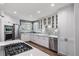 Modern kitchen featuring white cabinetry, stainless steel appliances, and stylish tile backsplash at 7630 S Monaco Way, Centennial, CO 80112