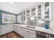 Bright kitchen with stainless steel appliances, white cabinets and blue backsplash at 7630 S Monaco Way, Centennial, CO 80112