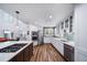 Bright and modern kitchen with white cabinets, stainless steel appliances, and a center island at 7630 S Monaco Way, Centennial, CO 80112