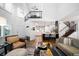 Bright, open-concept living area featuring high ceilings, hardwood floors, adjacent kitchen and staircase at 7630 S Monaco Way, Centennial, CO 80112