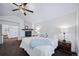 Comfortable main bedroom with a fireplace, bedside tables, and a ceiling fan at 7630 S Monaco Way, Centennial, CO 80112