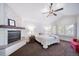 Spacious main bedroom featuring a cozy fireplace and a ceiling fan at 7630 S Monaco Way, Centennial, CO 80112