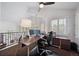 Bright home office with a ceiling fan, vaulted ceiling, and many large windows at 7630 S Monaco Way, Centennial, CO 80112