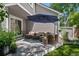 Relaxing outdoor patio space with comfortable seating under a large umbrella, ideal for enjoying the outdoors at 7630 S Monaco Way, Centennial, CO 80112