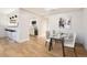 Bright dining area with glass table, modern art, and open layout to the kitchen at 4960 E Donald Ave # 11, Denver, CO 80222