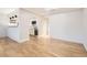 Bright living room featuring hardwood floors, open layout, and a view into the modern kitchen at 4960 E Donald Ave # 11, Denver, CO 80222